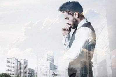 Image of Double exposure of a young businessman and city